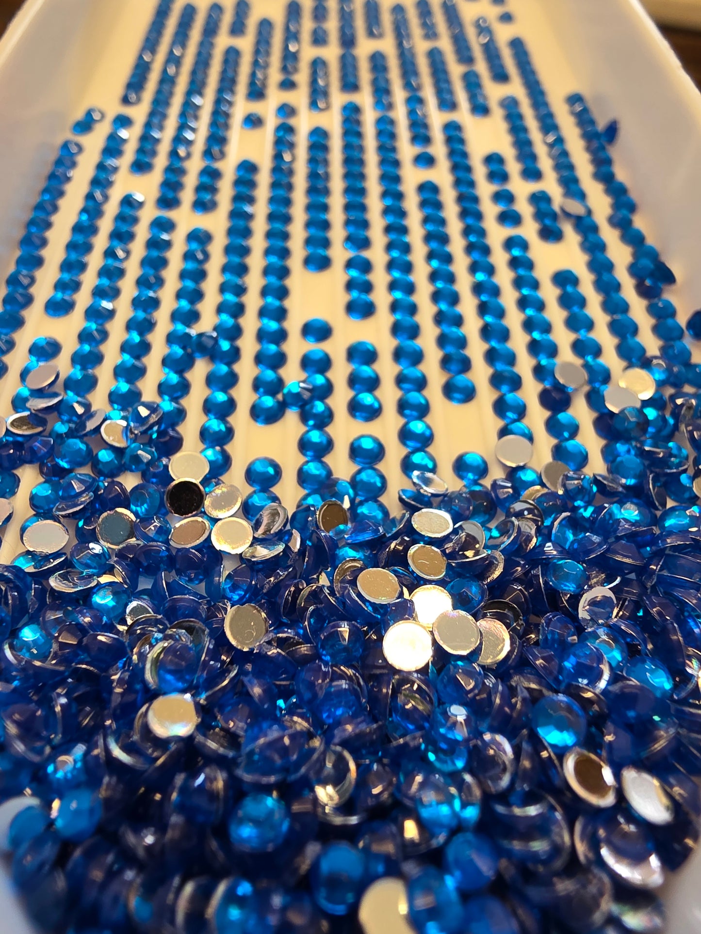 Round diamond painting drills from Silaba Crafts in various colors, arranged in a container for crystal craft projects.